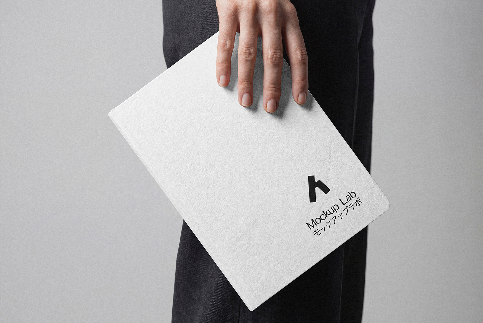 Angled shot of the notebook mockup, highlighting the cover and an interior page design.